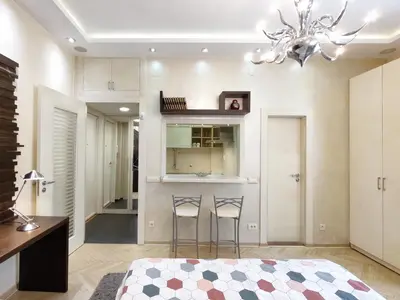 a bedroom with a bed and two bar stools at Home Center Apartment in Belgrade