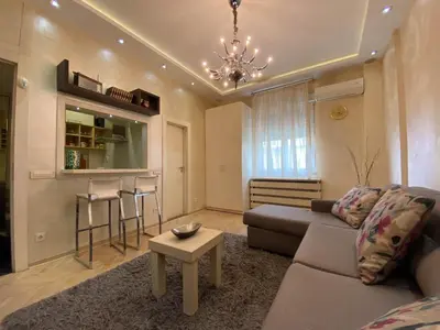 a living room with a couch and a table at Home Center Apartment in Belgrade