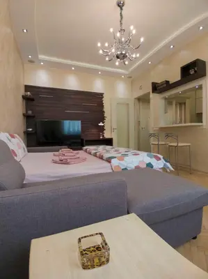 a large room with a large bed and a couch at Home Center Apartment in Belgrade