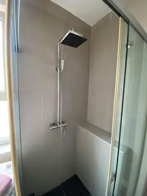 a shower with a glass door in a bathroom at Home Center Apartment in Belgrade