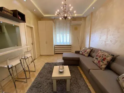 a living room with a couch and a table at Home Center Apartment in Belgrade