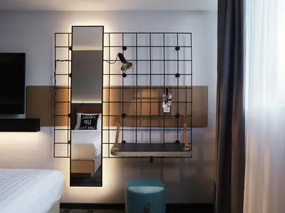 a room with a mirror and a bird on a wall at Moxy Belgrade in Belgrade