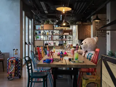 a teddy bear sitting at a table in a room at Moxy Belgrade in Belgrade