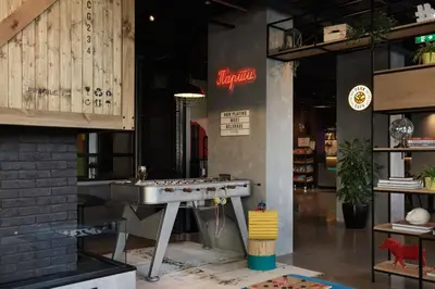 a kitchen with a sink in the middle of a room at Moxy Belgrade in Belgrade