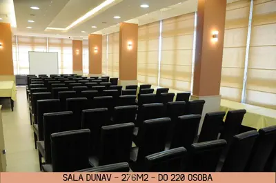 an empty lecture hall with black chairs and a whiteboard at Hotel Srbija-FREE PARKING in Belgrade
