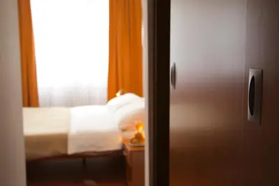 a bedroom with a bed and a window at Hotel Srbija-FREE PARKING in Belgrade