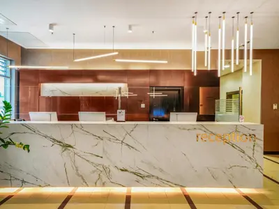 a lobby with a large marble counter in a room at IN Hotel Beograd in Belgrade