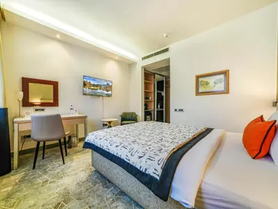 a hotel room with a bed and a desk and a desk at IN Hotel Beograd in Belgrade