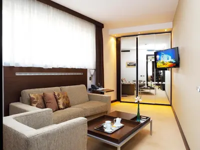 a living room with a couch and a table at IN Hotel Beograd in Belgrade