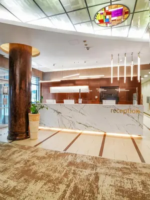 a lobby of a hotel with a reception counter at IN Hotel Beograd in Belgrade