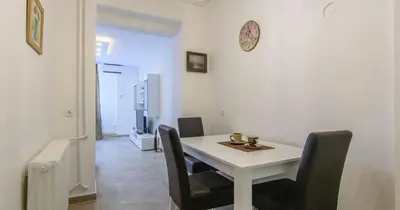 a dining room with a white table and chairs at Zone Dedinje in Dedinje