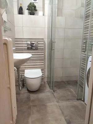 a bathroom with a toilet and a sink and a shower at Zone Dedinje in Dedinje