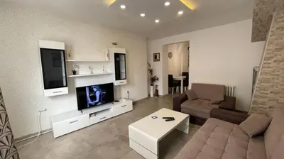 a living room with a couch and a flat screen tv at Zone Dedinje in Dedinje