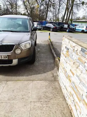 a white car parked in a parking lot at Zone Dedinje in Dedinje