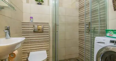 a bathroom with a toilet and a sink and a shower at Zone Dedinje in Dedinje