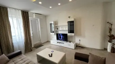 a living room with a couch and a tv at Zone Dedinje in Dedinje