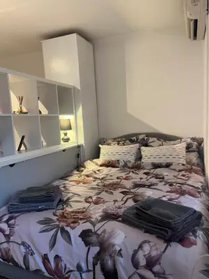 a bedroom with a bed with a floral bedspread at Bellissima Apartment in Belgrade