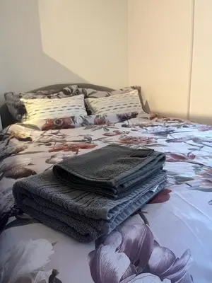a bed with a pile of towels on it at Bellissima Apartment in Belgrade