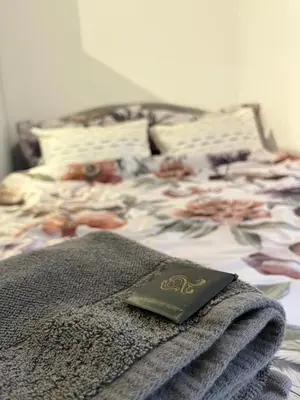 a bed with a book sitting on top of it at Bellissima Apartment in Belgrade