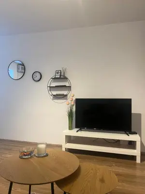 a living room with a tv and a table at Bellissima Apartment in Belgrade