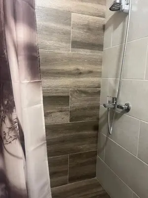 a bathroom with a shower with a glass door at Bellissima Apartment in Belgrade