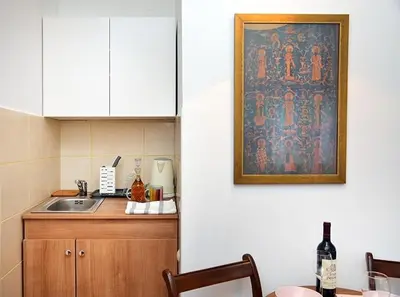 a kitchen with a sink and a painting on the wall at Studio Milan in Vračar (historical)