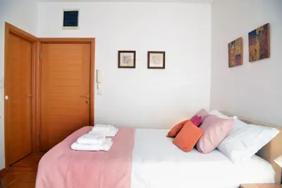 a bedroom with a bed with towels on it at Studio Milan in Vračar (historical)