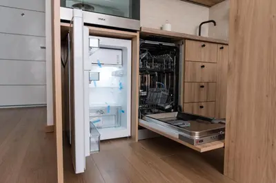a refrigerator with its door open in a kitchen at Cube23 in Belgrade
