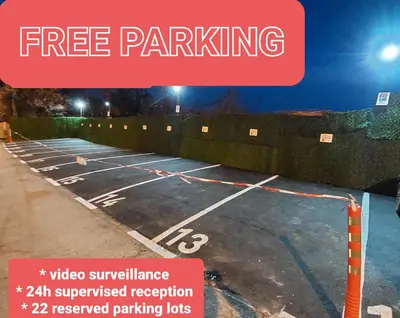 a parking lot with a sign that says free parking at Hotel Villa Panorama in Belgrade