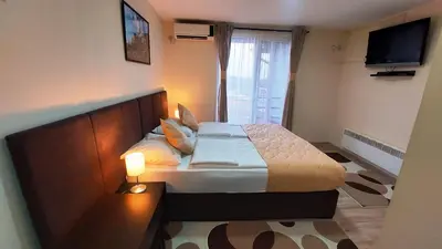 a bedroom with a bed and a television in it at Hotel Villa Panorama in Belgrade