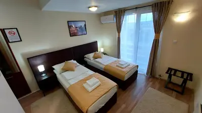 a hotel room with two beds and a window at Hotel Villa Panorama in Belgrade