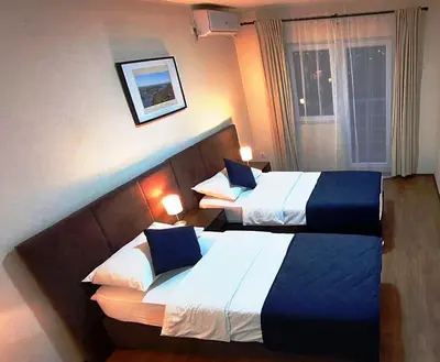 a hotel room with two beds and a window at Hotel Villa Panorama in Belgrade
