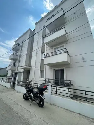 a motorcycle parked in front of a building at LL65 Apartmens Airport Nikola Tesla in Ledine