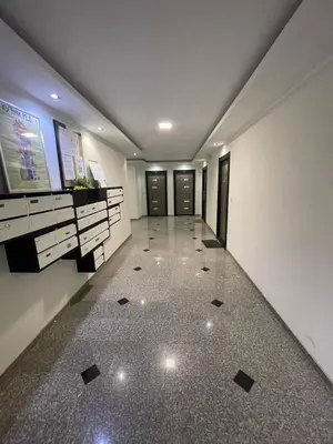a hallway of a building with doors and a tile floor at LL65 Apartmens Airport Nikola Tesla in Ledine