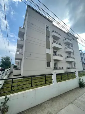 a white building with balconies on the side of it at LL65 Apartmens Airport Nikola Tesla in Ledine
