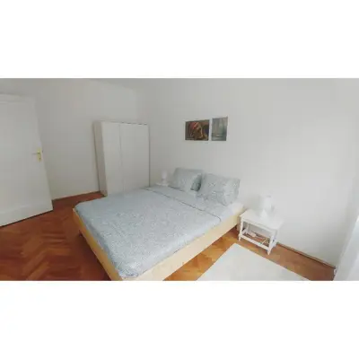 a small bedroom with a bed in a room at Kennedy apartment in Tošin Bunar