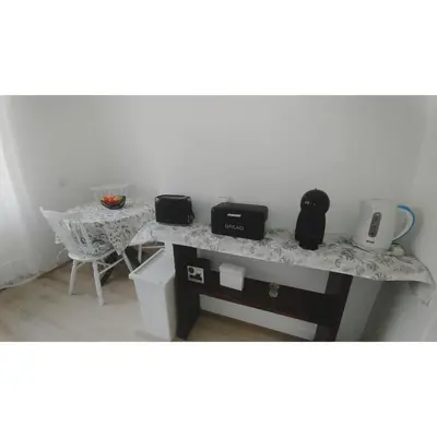 a table with three appliances on top of it at Kennedy apartment in Tošin Bunar