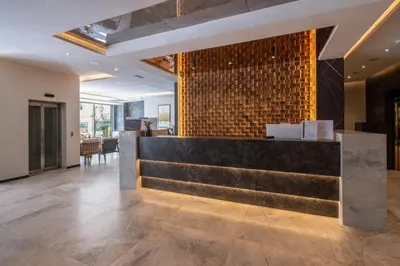 a lobby of a hotel with a reception counter at Nobel Design Hotel in Belgrade