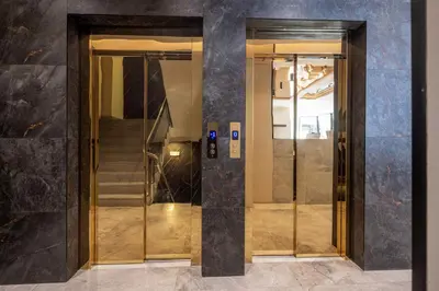 two elevators in a building with doors and stairs at Nobel Design Hotel in Belgrade