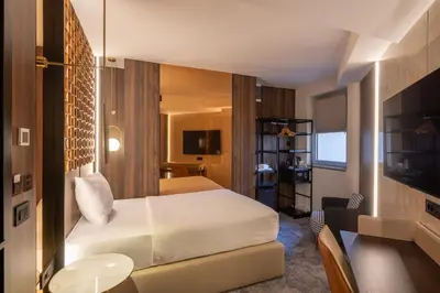 a hotel room with a bed and a television at Nobel Design Hotel in Belgrade