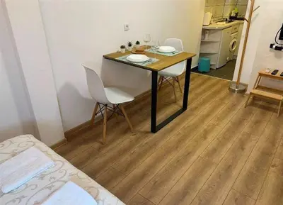 a room with a table and chairs in a room at Cozy & fully equipped studio in the heart of downtown and next to Kalemegdan in Belgrade