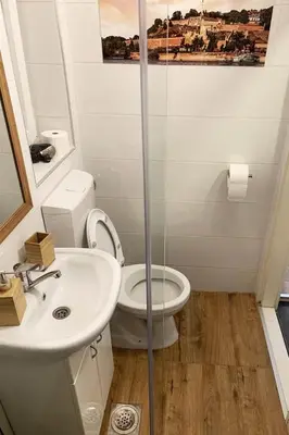 a bathroom with a toilet and a sink at Cozy & fully equipped studio in the heart of downtown and next to Kalemegdan in Belgrade
