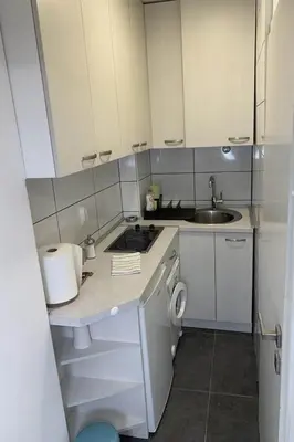 a small kitchen with a sink and a stove at Cozy & fully equipped studio in the heart of downtown and next to Kalemegdan in Belgrade