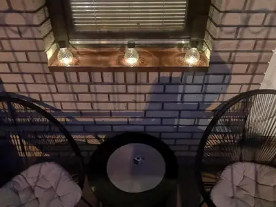 a room with two chairs and a window with lights at Apartman Darvin / Lux in Belgrade