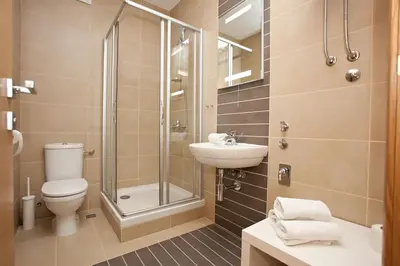 a bathroom with a shower toilet and a sink at Boutique Apartments 360º in Belgrade