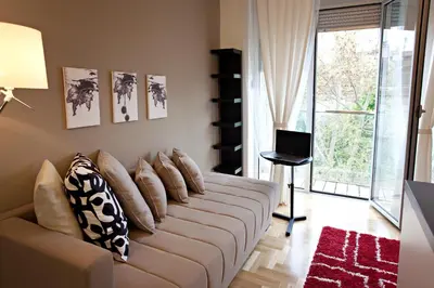a living room with a couch with pillows on it at Boutique Apartments 360º in Belgrade