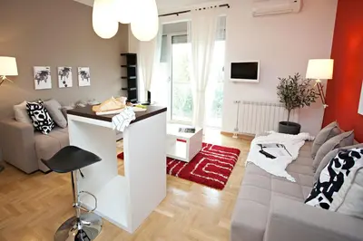 a living room with a couch and a table at Boutique Apartments 360º in Belgrade