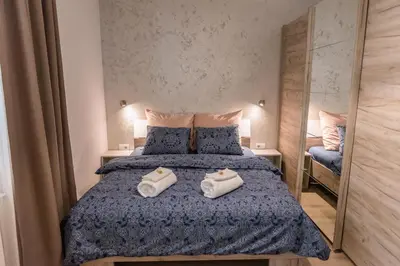 a bedroom with a bed with two towels on it at Apartman Mila23 in Rospi Ćuprija