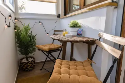 a tiny house with a table and a chair at Apartman Mila23 in Rospi Ćuprija