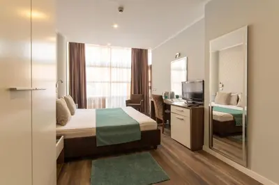 a hotel room with a bed and a mirror at Balkan Hotel Garni in Belgrade